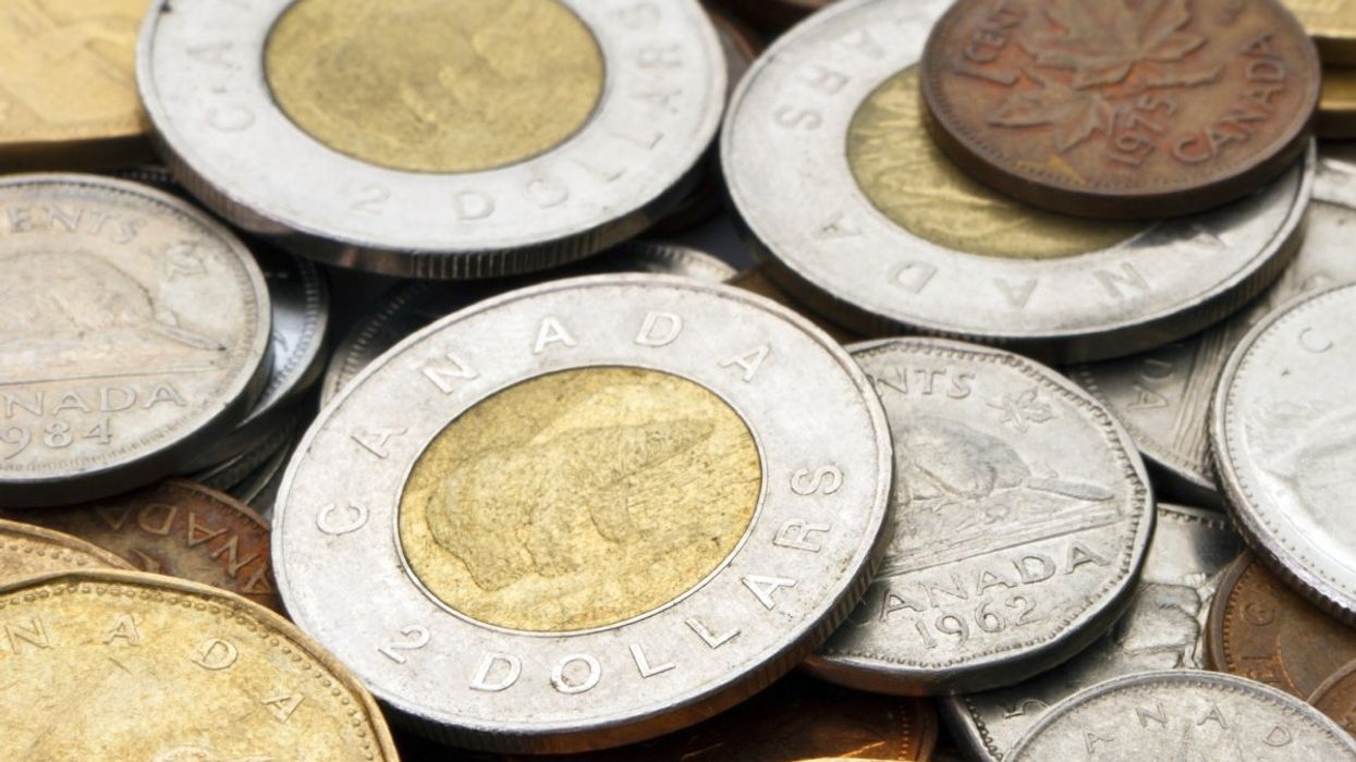 A pile of Canadian coins including a Canadian toonie ($2 coin), nickel ($0.05 coin), dimes ($0.10 coin) and the discontinued Canadian penny ($0.01).