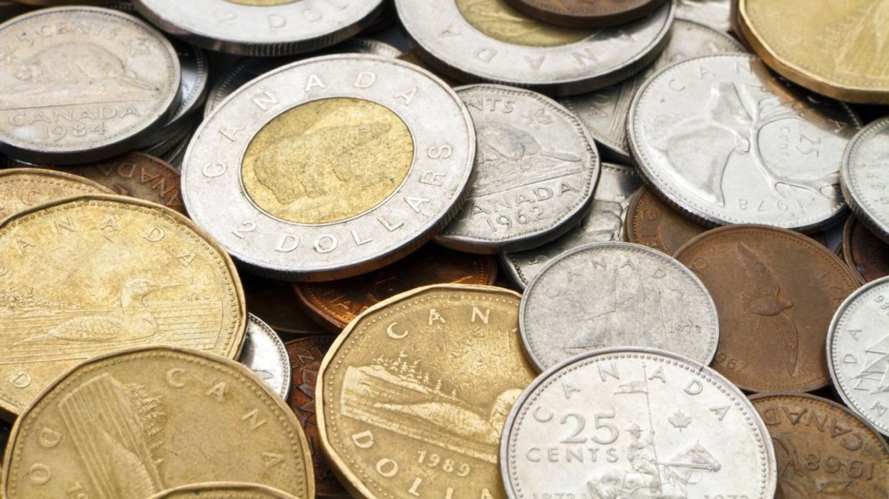A pile of Canadian coins including loonies ($1 coin), toonies ($2 coin), quarters, dimes, nickels and the discontinued penny.