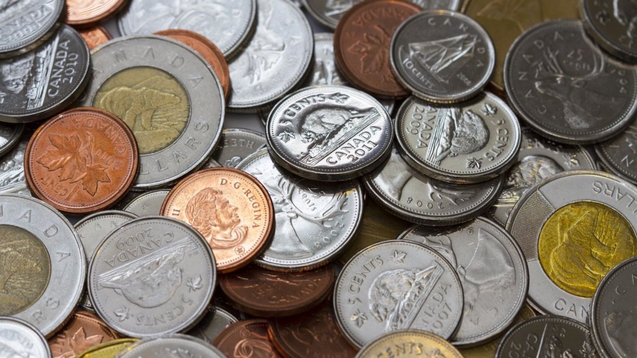 A pile of Canadian coins made up of toonies ($2 coin), loonies ($1 coin), quarters, dimes, nickels and the discontinued penny.
