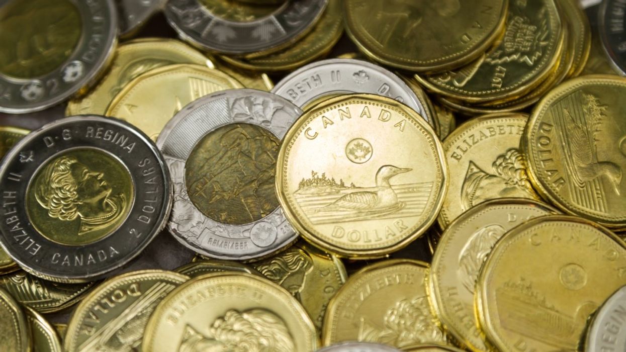 A pile of Canadian loonies ($1 coin) and toonies ($2 coin).