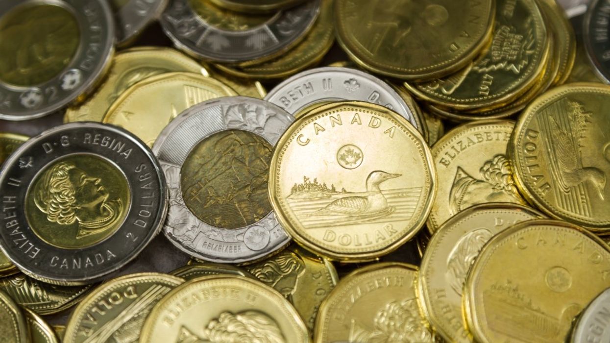 A pile of Canadian loonies ($1 coins) and toonies ($2 coins).