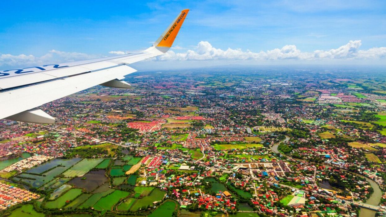 A plane flies over Manila, Philippines.