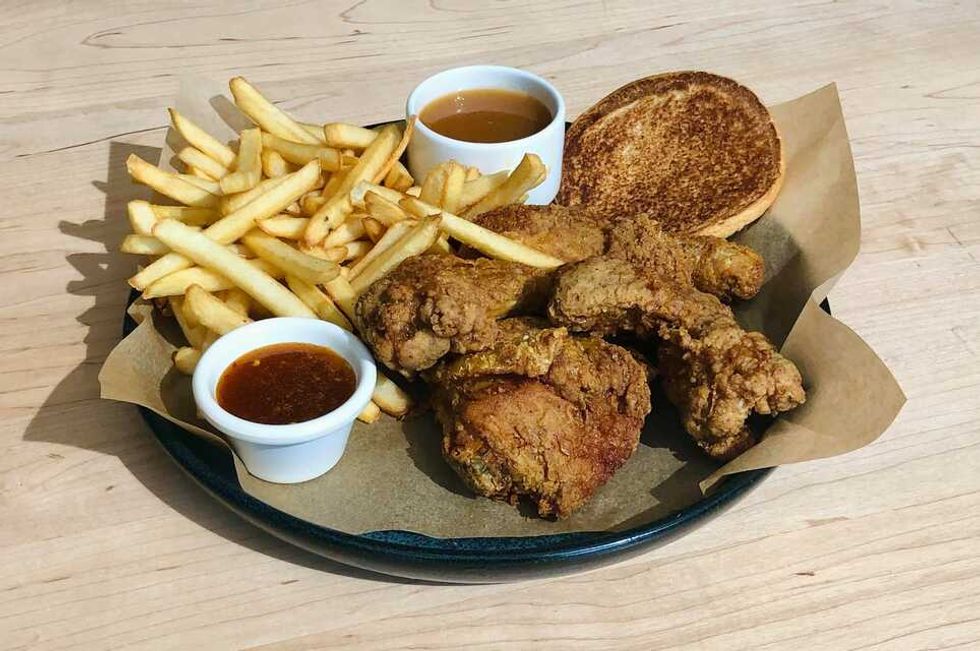 A plate of fried chicken, sauce and fries