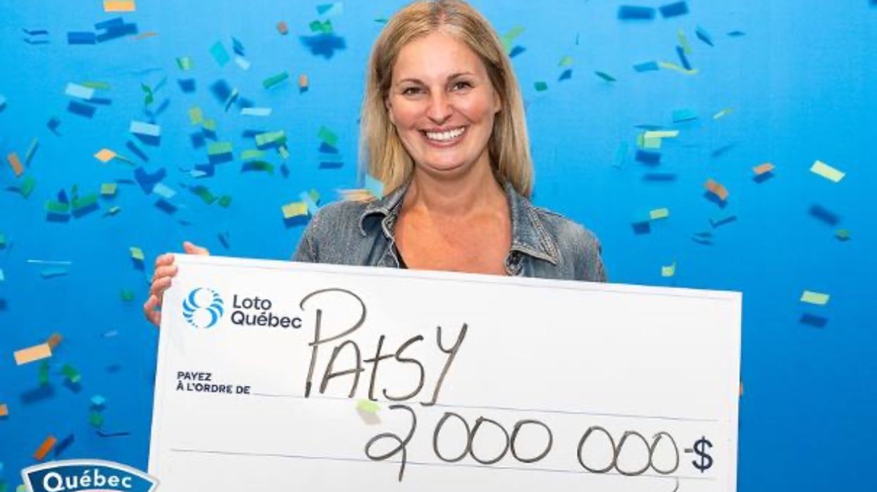 A Quebec 49 lottery winner holding a giant cheque for $2,000,000 at the Loto-Quebec headquarters in Montreal.