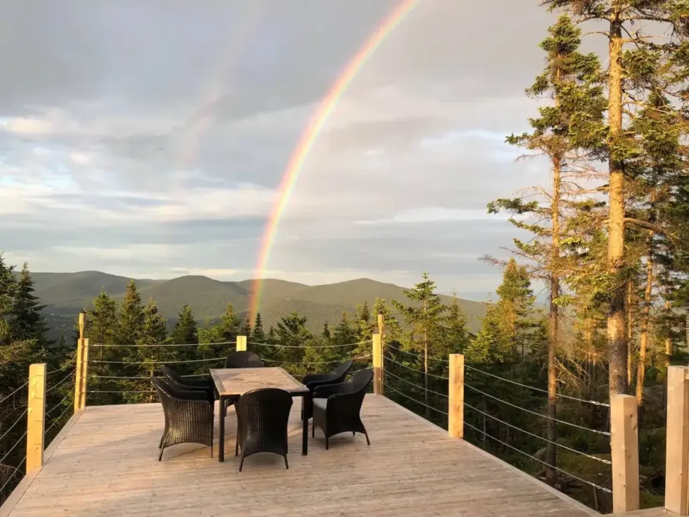A rainbow over the trees, visible from the deck.