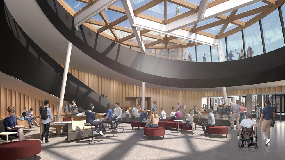 Una representación muestra personas en un edificio circular con techo transparente.