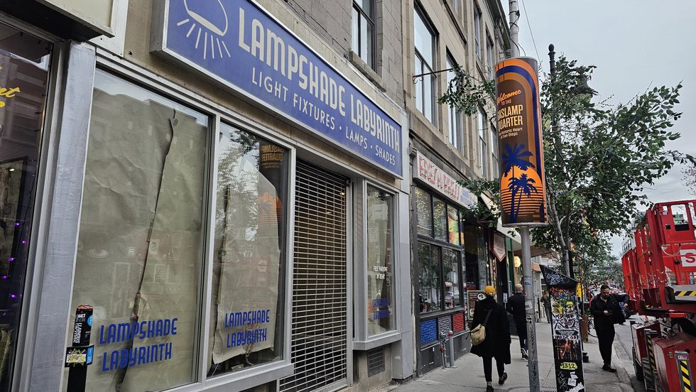 A retro blue sign for fake storefront, "Lampshade Labyrinth."