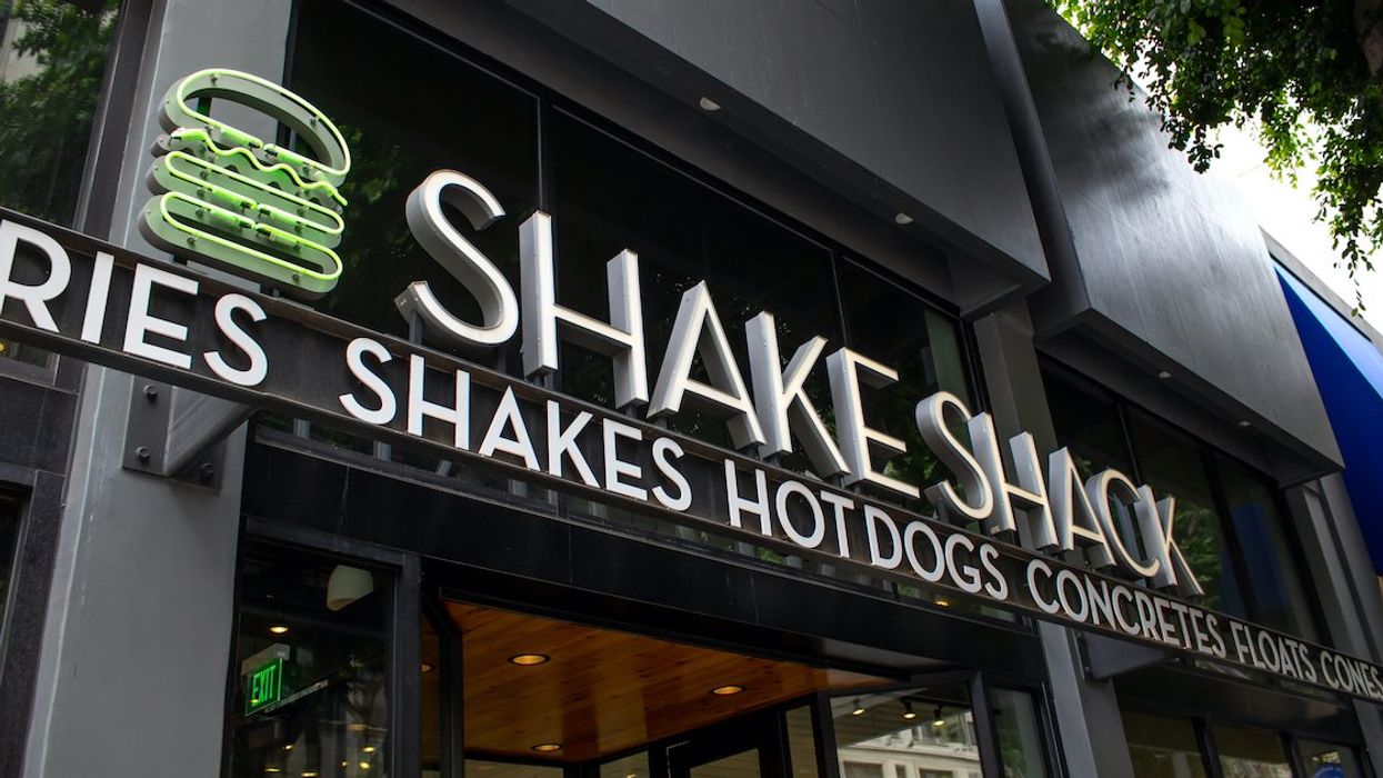 A Shake Shack sign above a restaurant entrance.