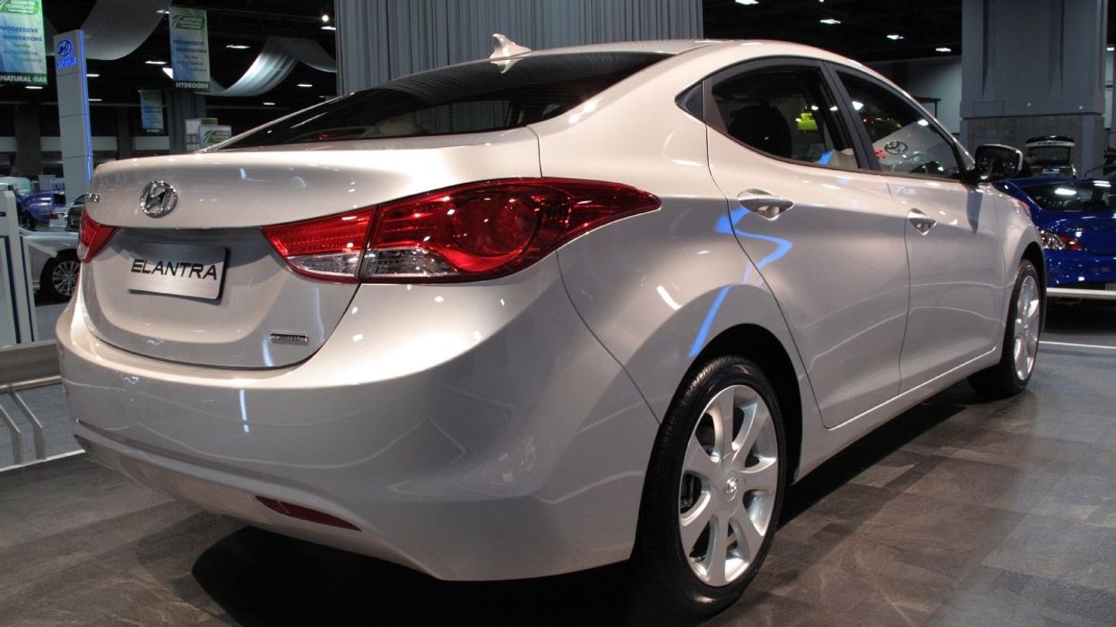 A silver Hyundai Elantra sedan parked inside a Hyundai car dealership.
