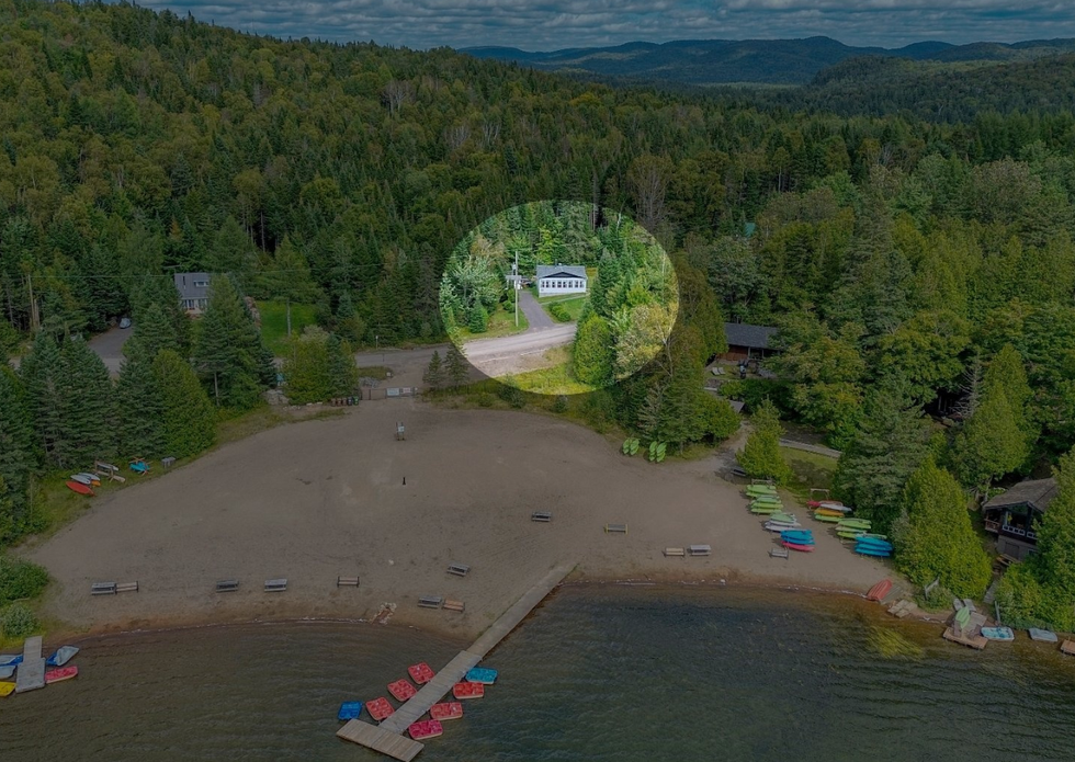 A small white house on the lakefront.