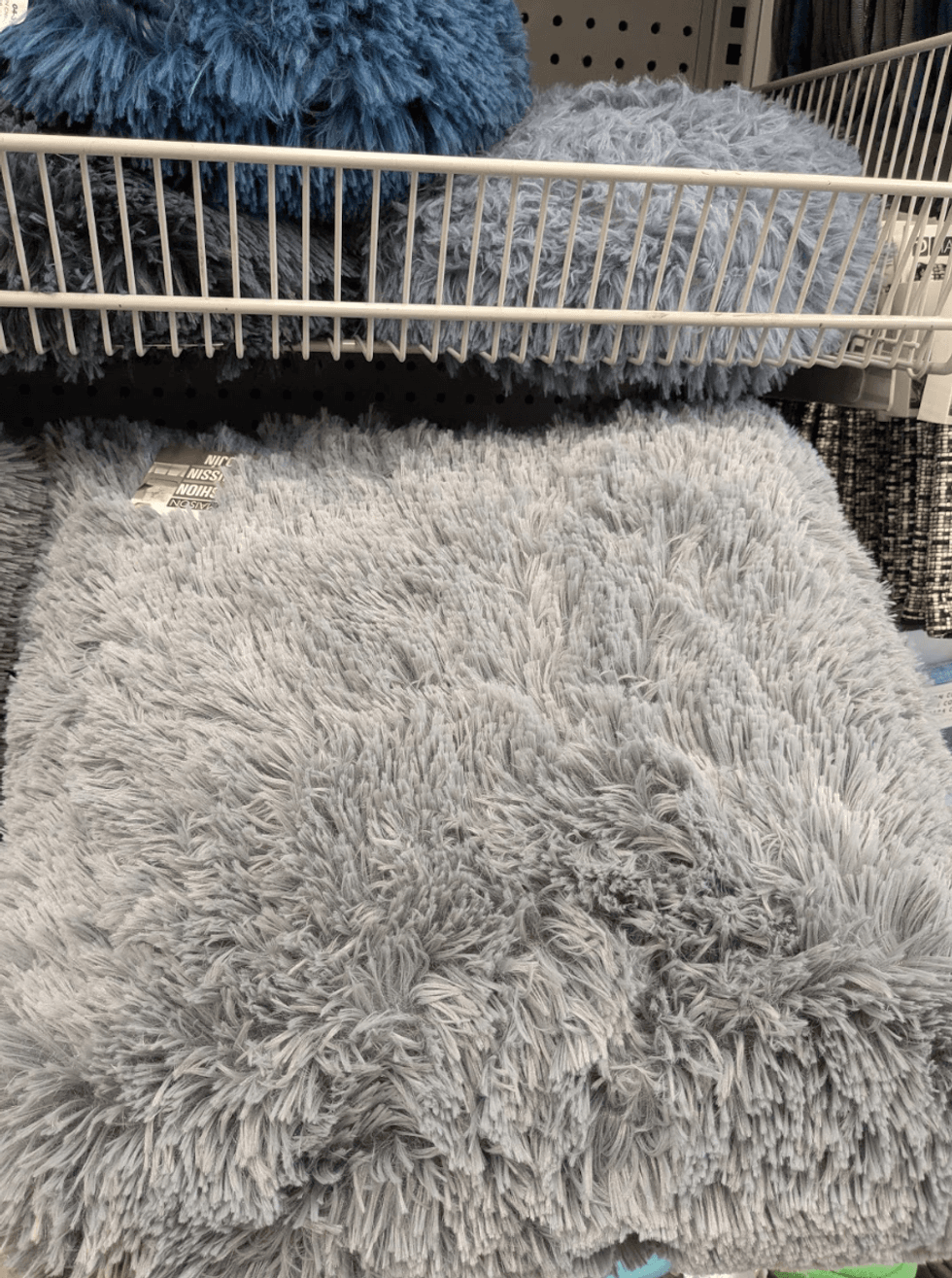 A soft grey throw pillow from Dollarama
