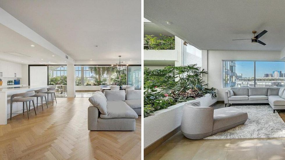 A spacious, open-concept living and dining area with floor-to-ceiling windows overlooks a tropical atrium, filling the space with natural light and greenery.