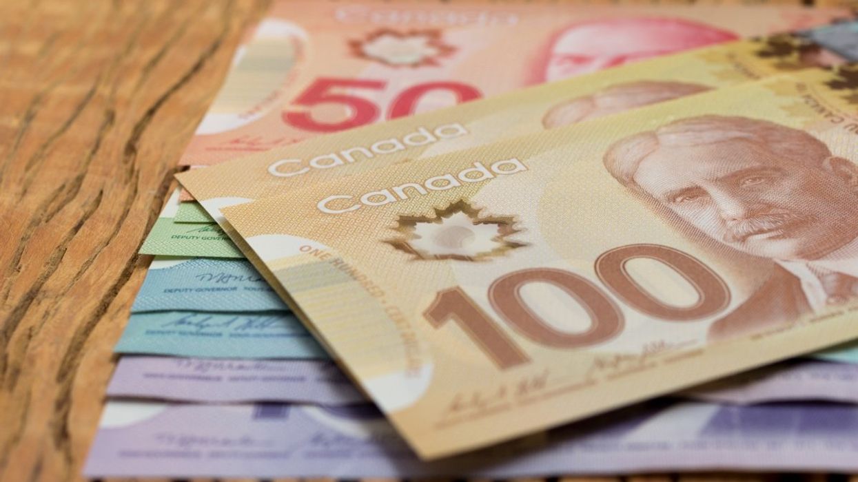 A stack of Canadian banknotes including a $100, $50, two $20, $10 and $5 bills.