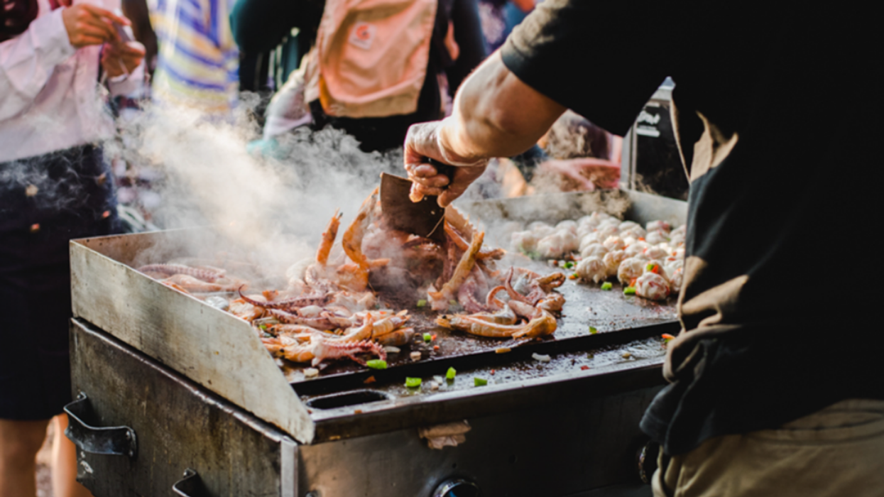 A street food vendor cooking food at StreetFood Montreal festival in 2022.