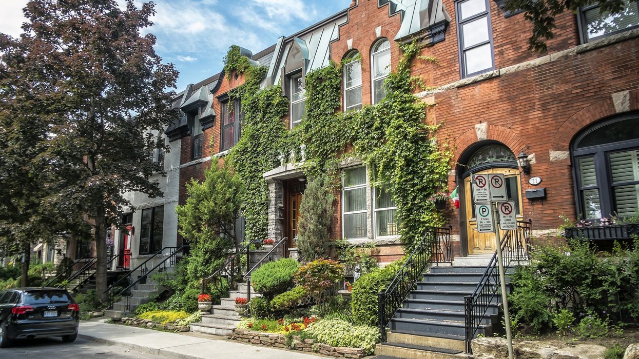 A strip of nice-looking brick townhomes and/or apartments, crawling with ivy.