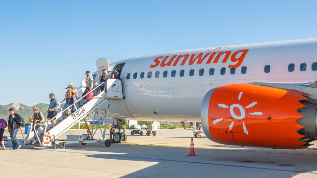 A Sunwing flight lands at an airport in Mexico.