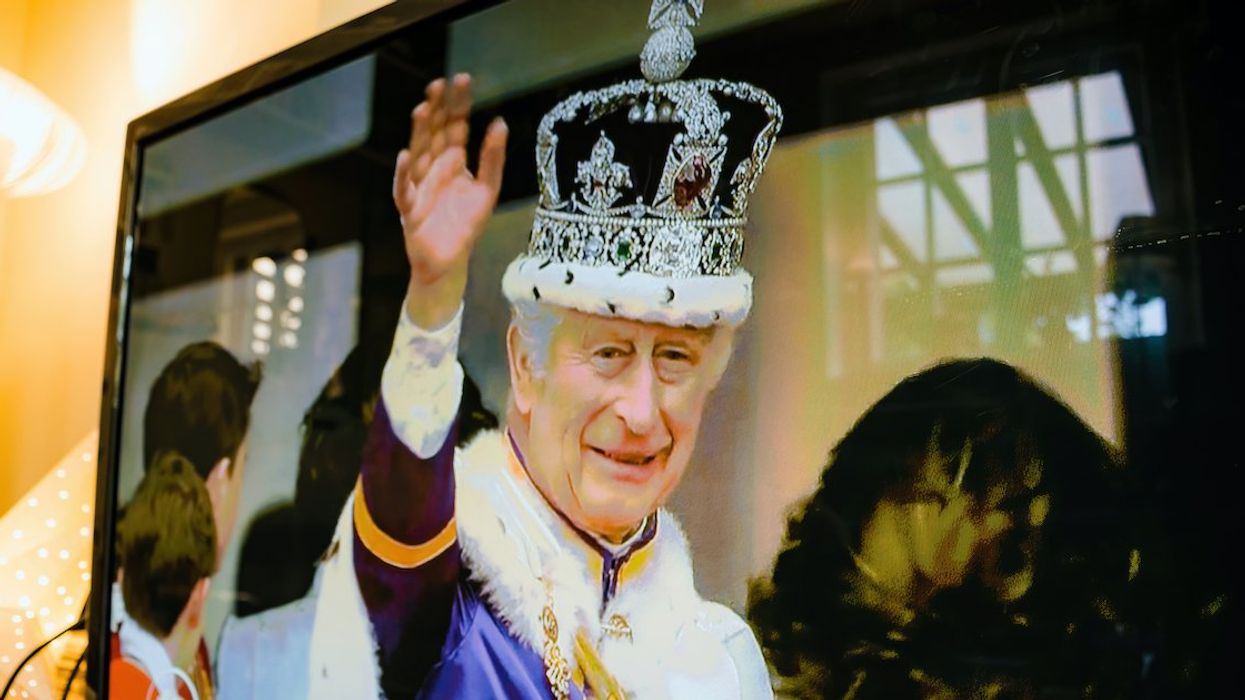 A television screen displays an image of King Charles III following his coronation.
