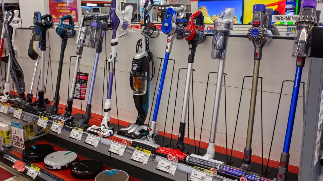 A variety of vacuums for sale at a store.