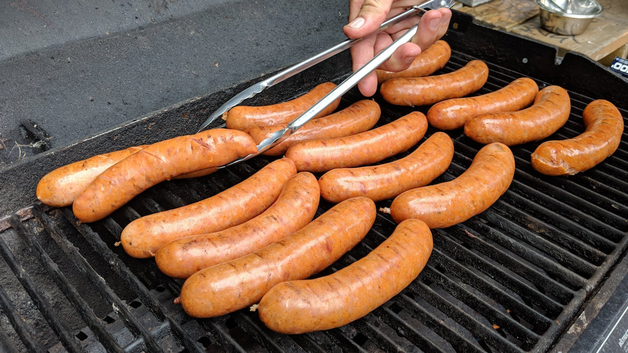 A vendor prepares sausages at Polski Piknik.