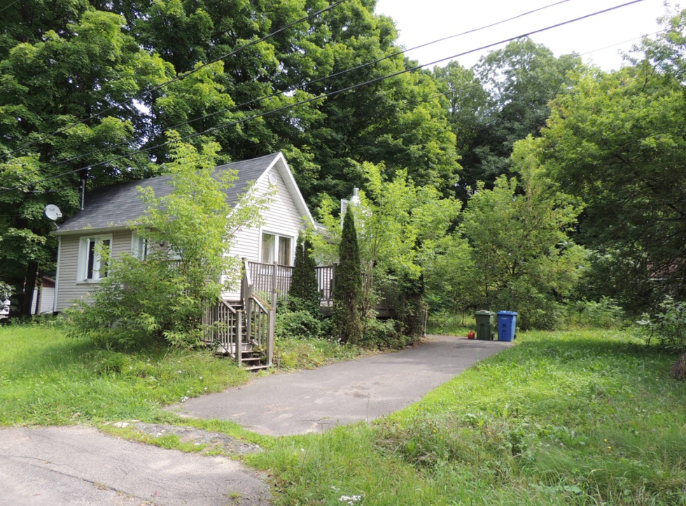 A view of a small white cottage.