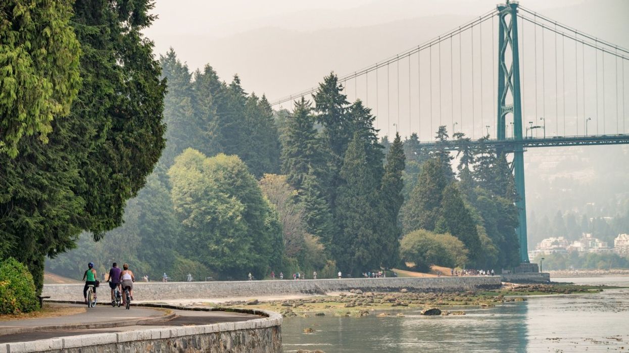 A view of people biking along the Stanley Park promenade in Vancouver, British Columbia.