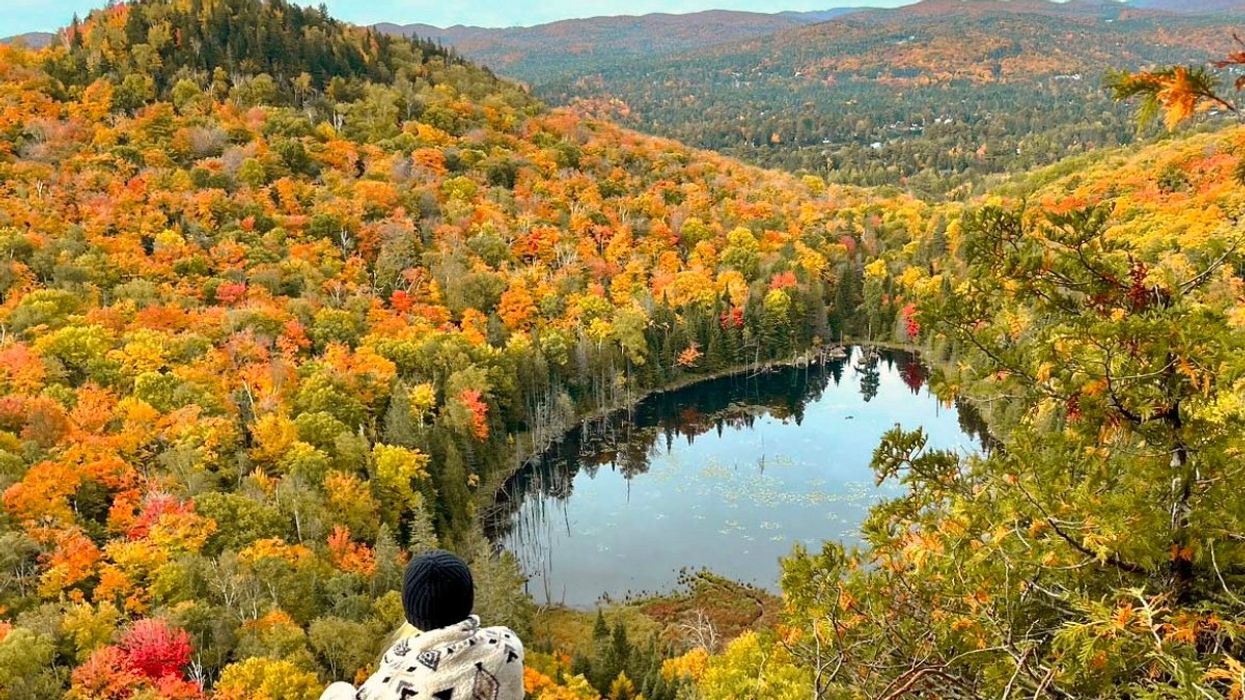 A view of someone overlooking Mont King in Val-David, Quebec during the autumn season.