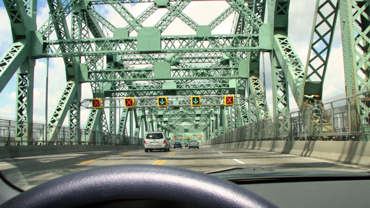 A view of the Jacques-Cartier bridge from the driver's seat of a car.