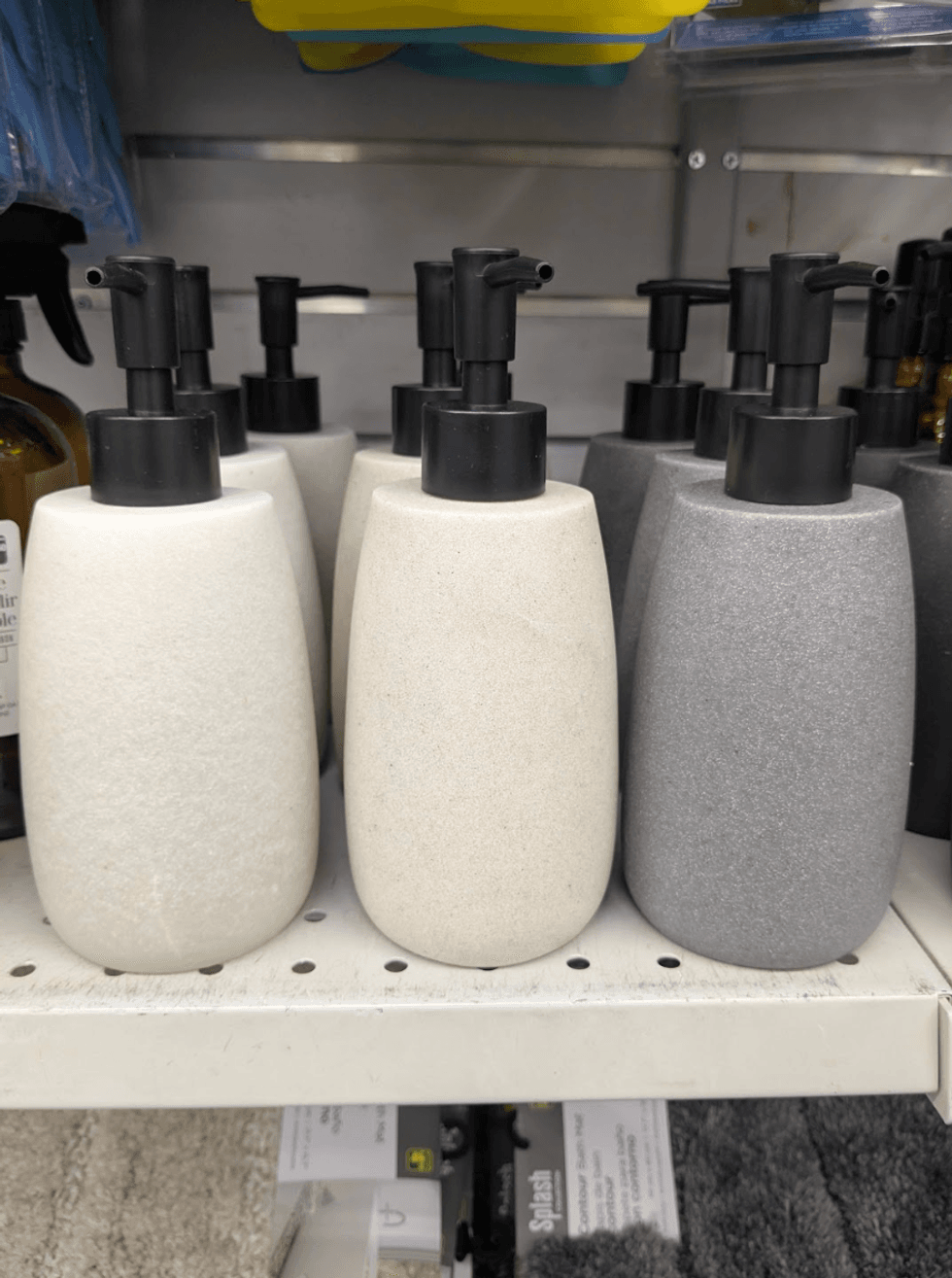 A white marble-patterned soap dispenser with a pump