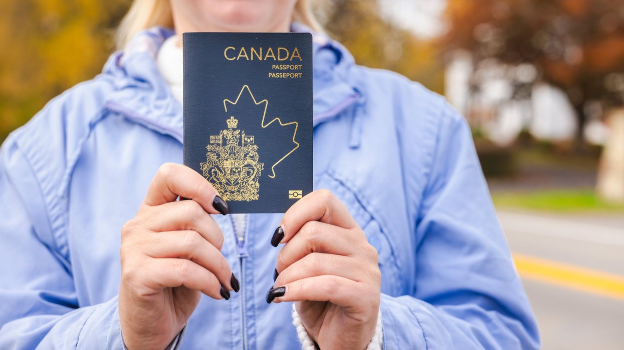 A woman holding a Canadian passport.