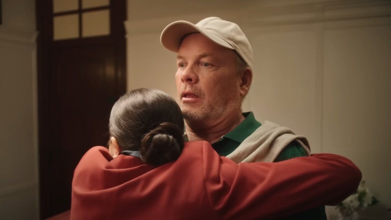A woman hugging a man at a Quebec hotel.