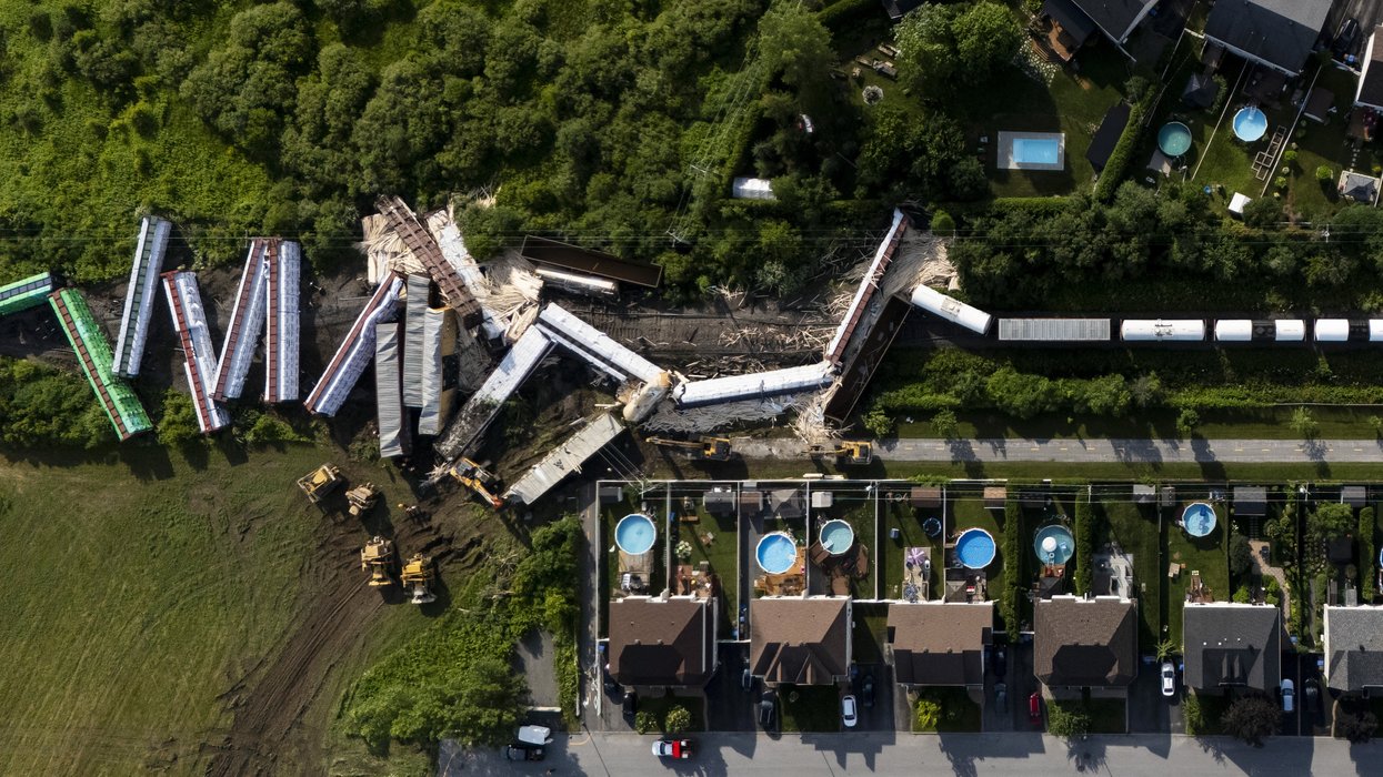 Aerial view of a derailed cargo train.