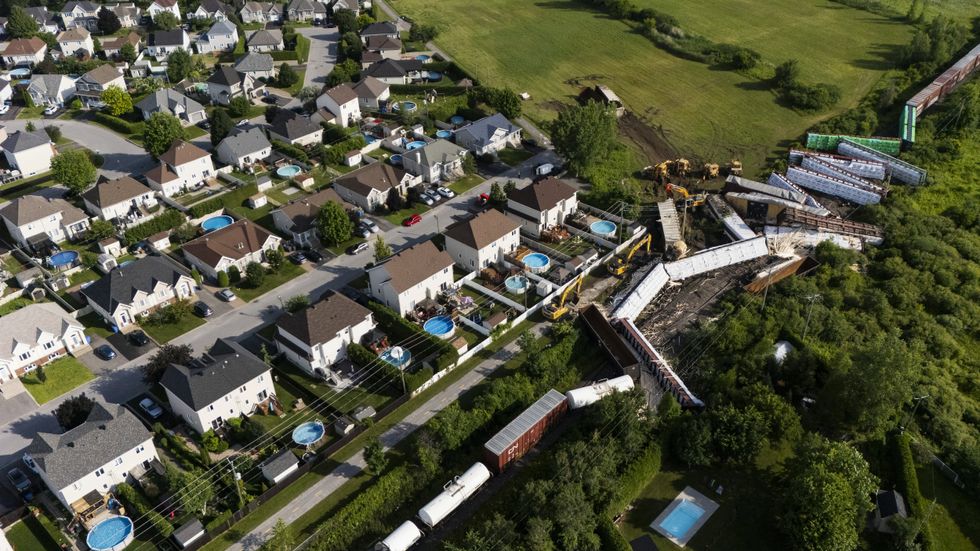 Aerial view of cleanup of a derailed cargo train.