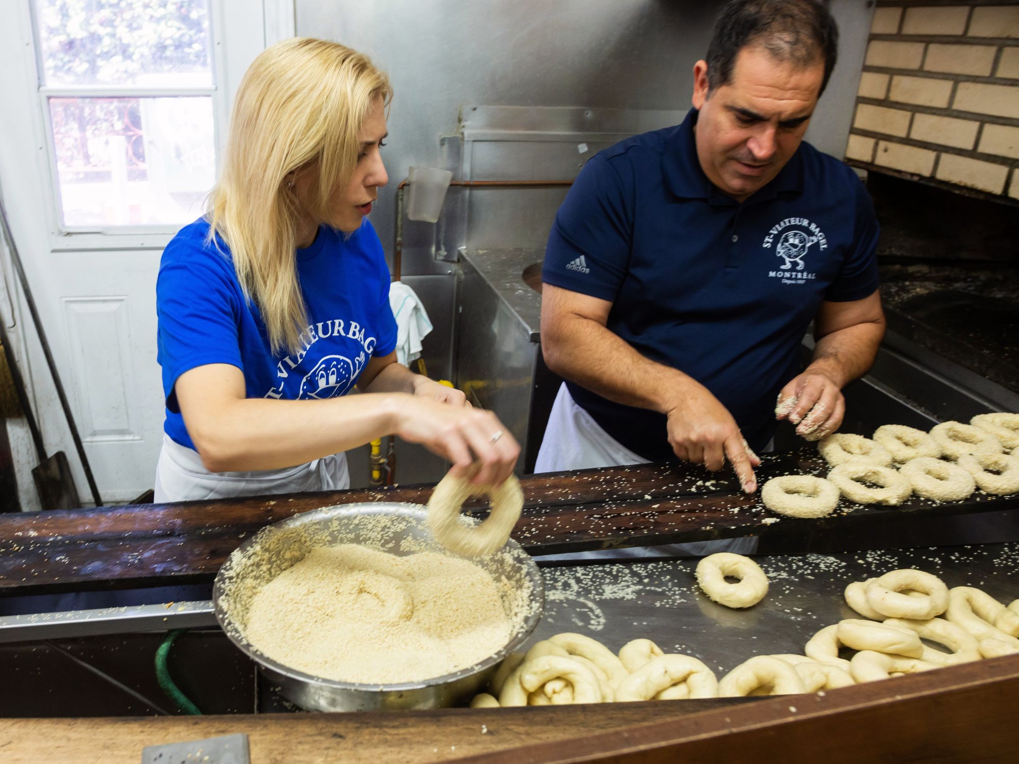 After their steamy honey dip, the bagels are piping hot, so a quick shimmy in the sesame seeds cools thems off.