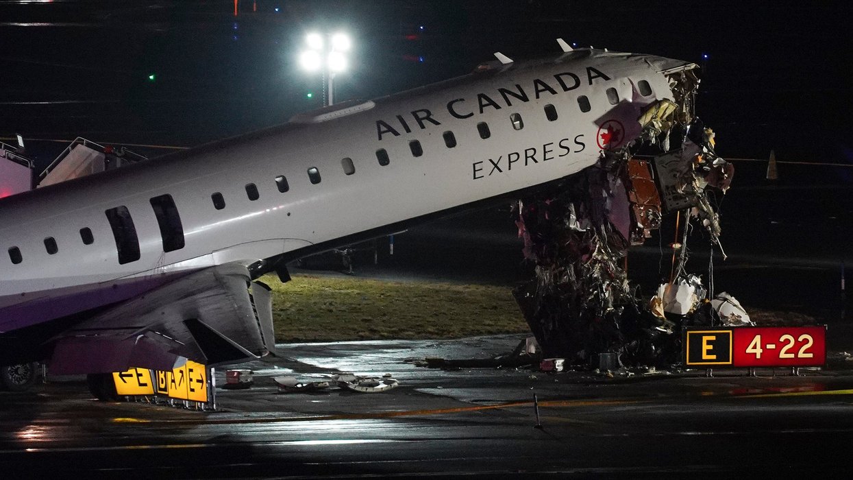 Air Canada plane crash wreckage on a runway.