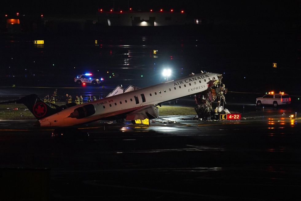 Air Canada plane crash wreckage on a runway.