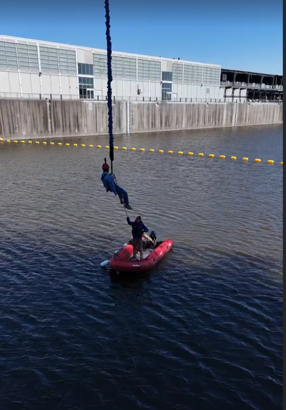 Al Sciola is lowered into a boat after bungee jumping.