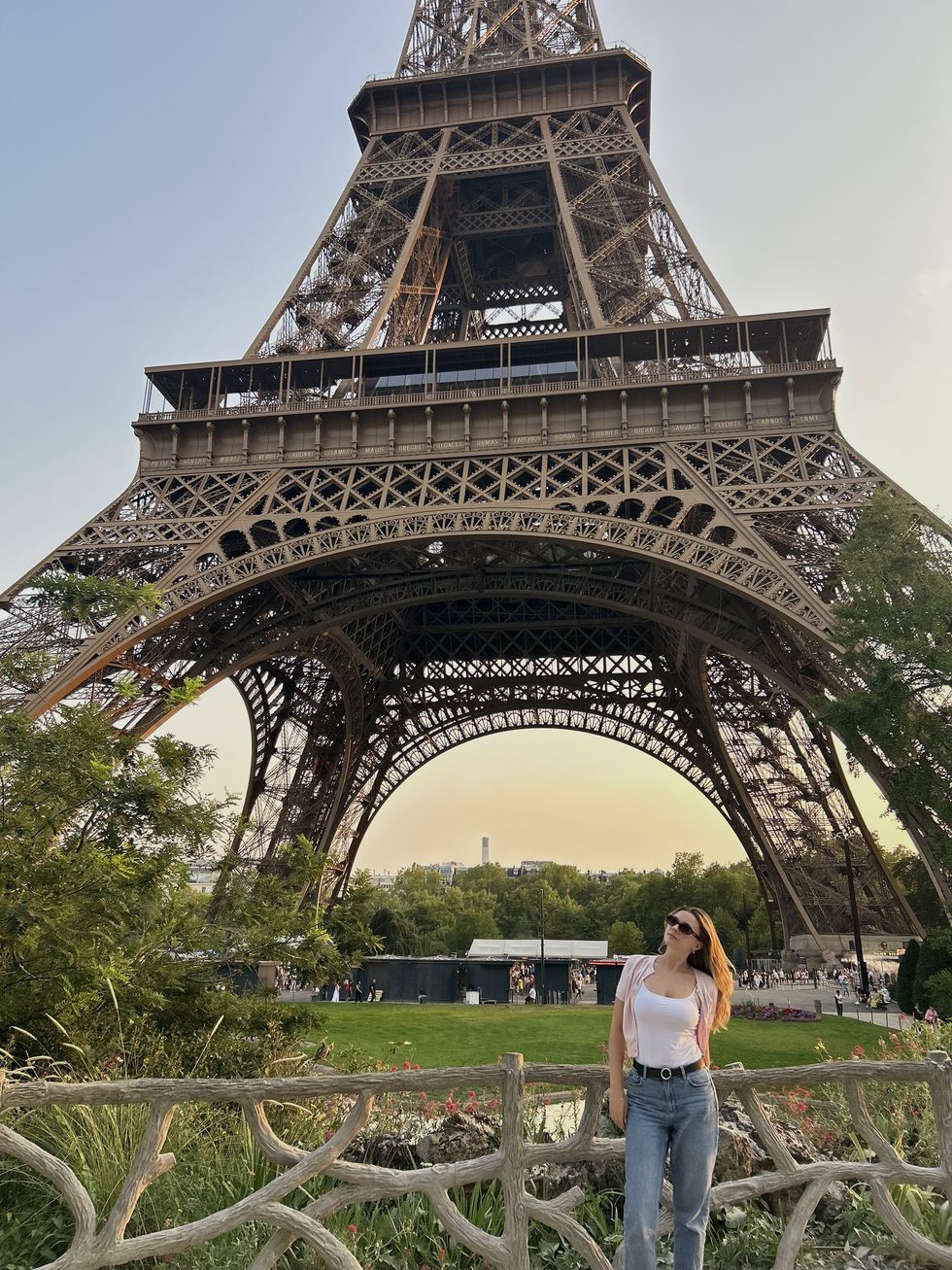 Alycia Poirier poses beside the Eiffel Tower.