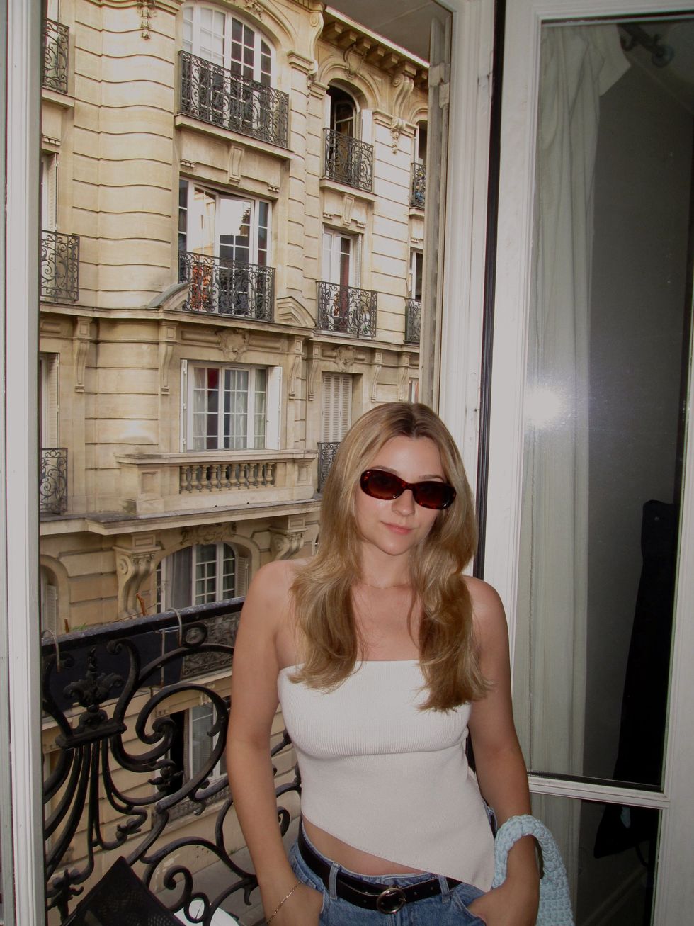 Alycia Poirier poses in a hotel room in France.