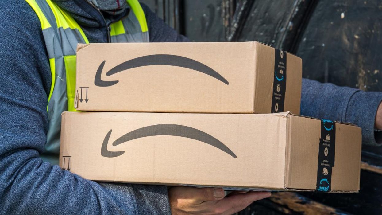 Amazon driver delivering packages to door.