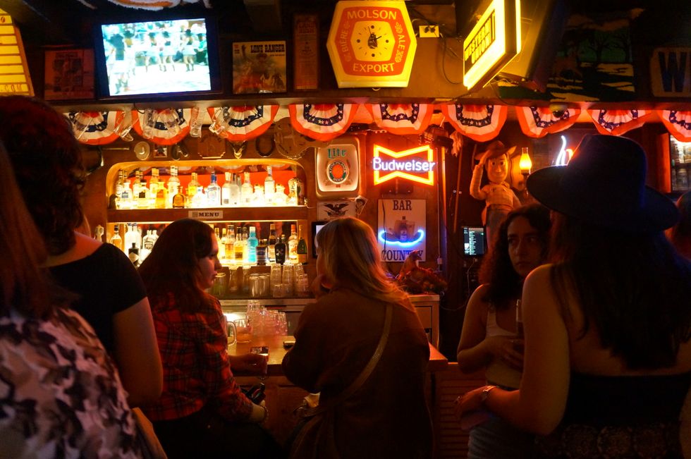 Americana-themed decor, including neon signs, around the bar area at Spaghetti Western.