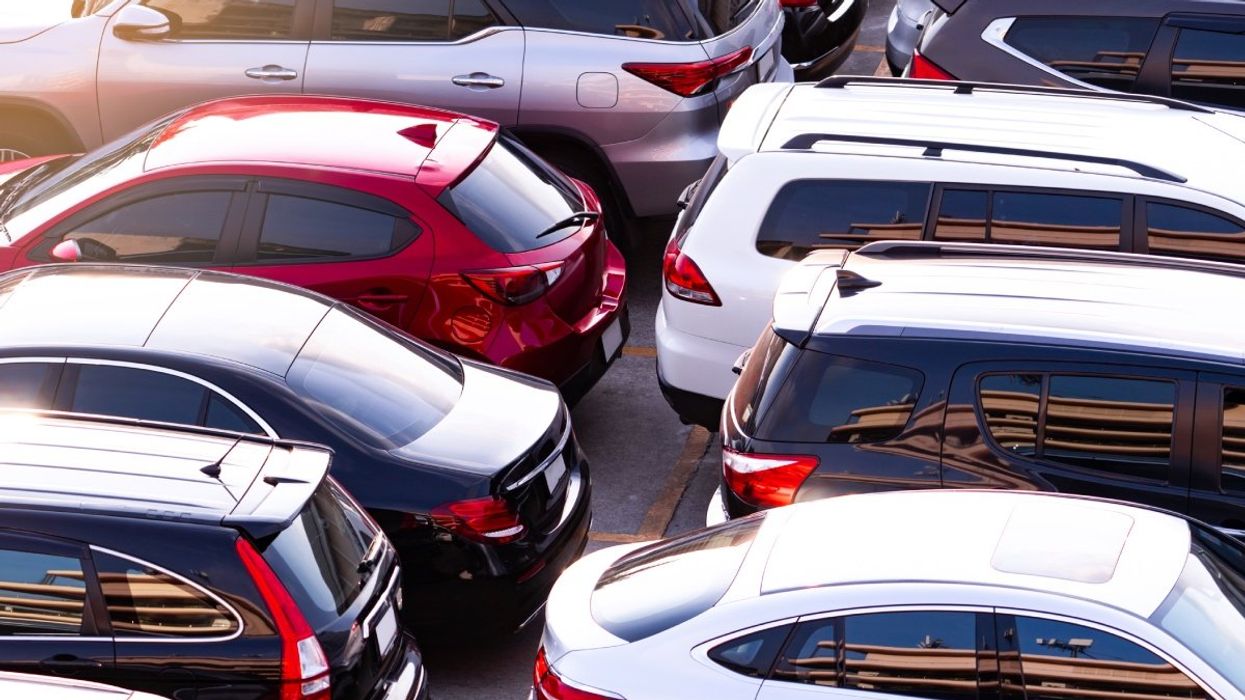An aerial view of cars parked in the parking lot of a shopping mall.