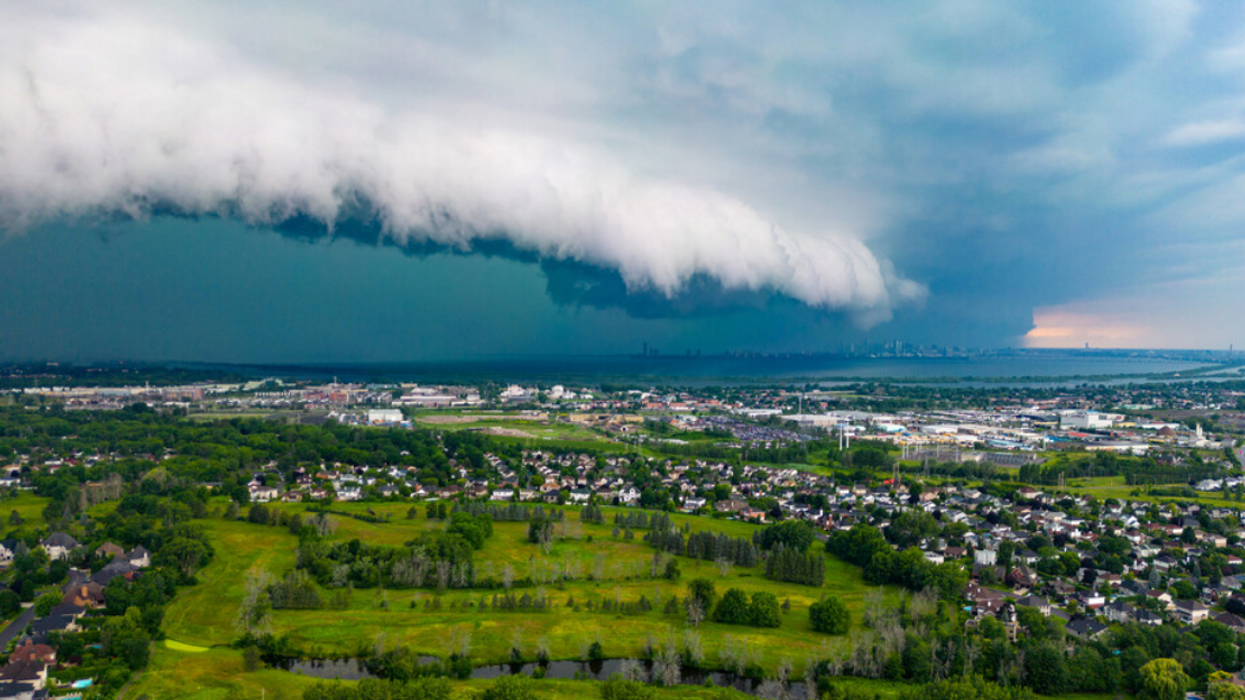 An aerial view of Montreal homes, green spaces and water as a tornado touches down.