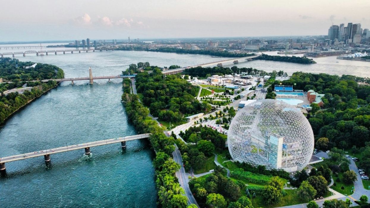 An aerial view of Parc Jean-Drapeau in Montreal with views of the St. Lawrence river, Biosphere and the Montreal skyline.