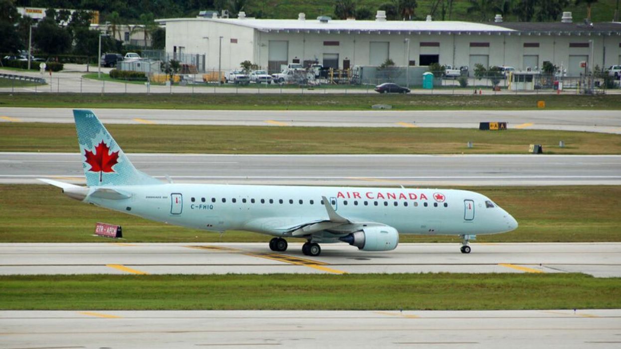 An Air Canada plane parked on an airport tarmac.