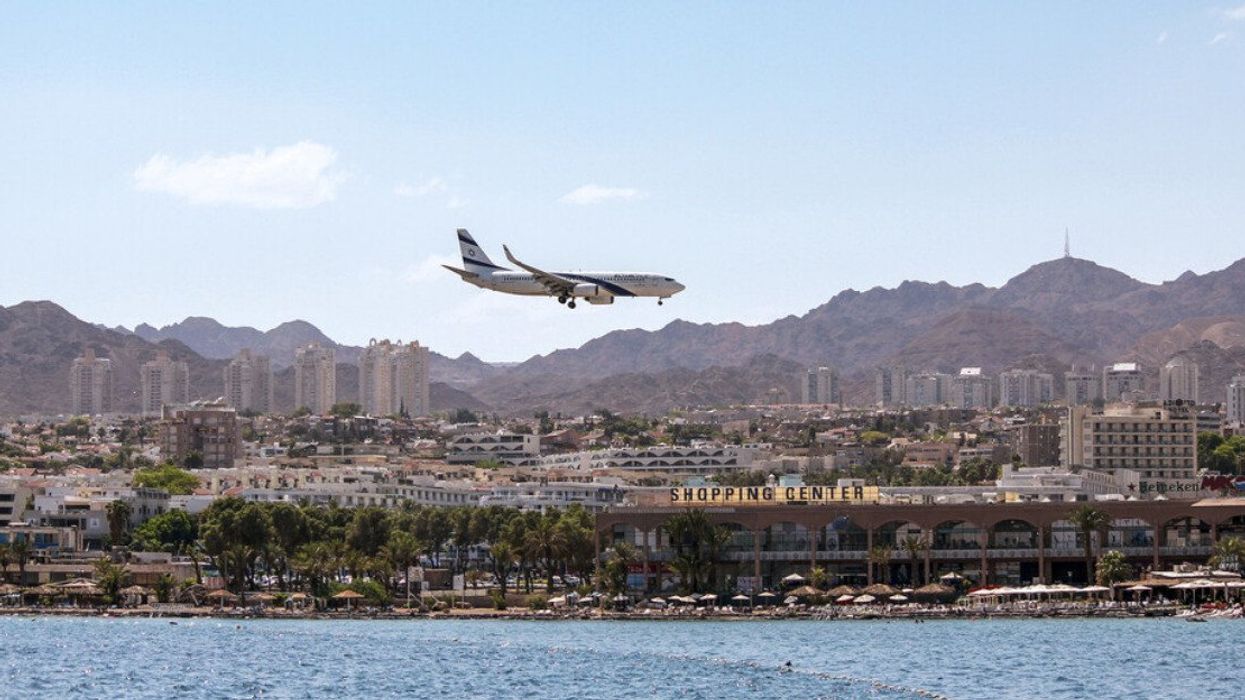 An airplane flies over Eilat, Israel.