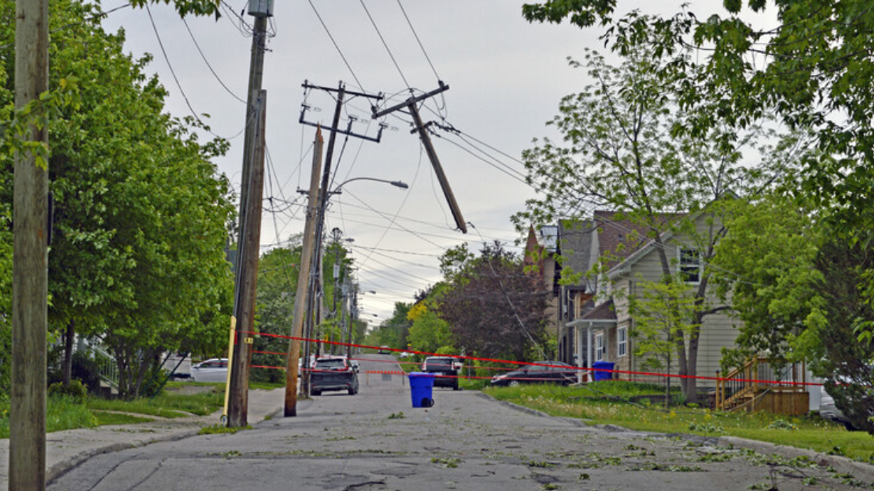 An electrical grid post with power lines snapped in half after a massive storm in Quebec, Canada.