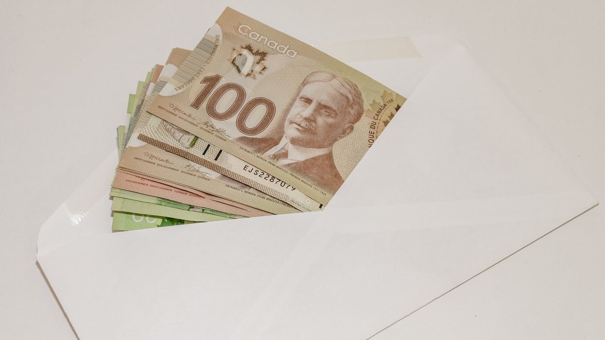 An envelope full of Canadian bills (illustrative).