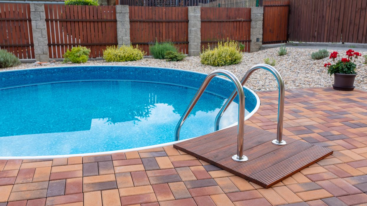 An in-ground pool in a backyard.