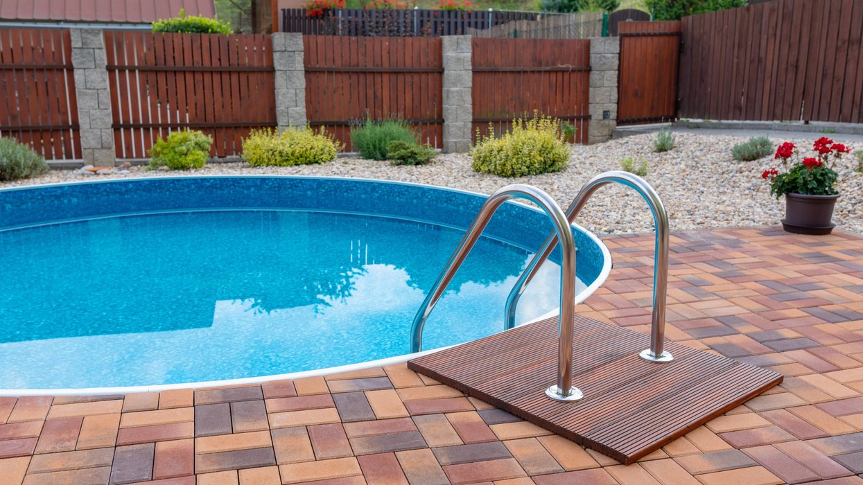 An in-ground pool in a backyard.