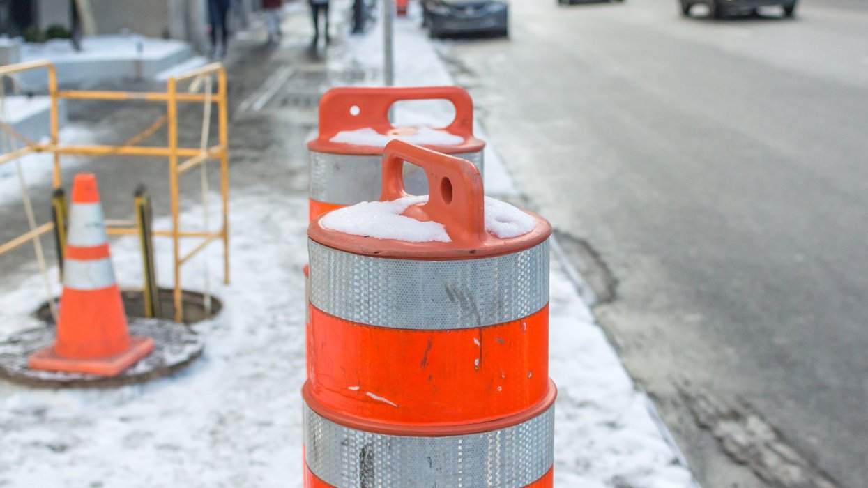 An orange traffic cone on the sidewalk in Montreal downtown, Canada.